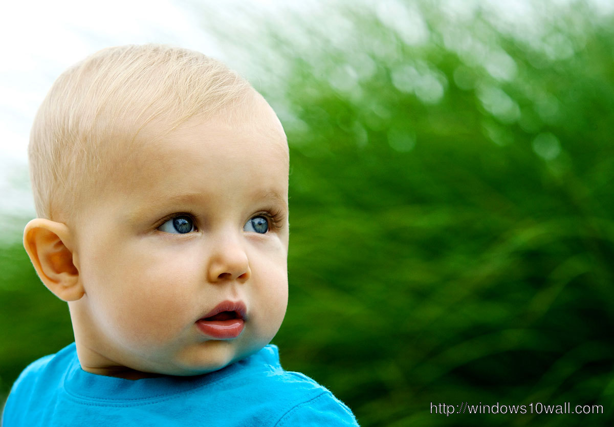 Sweet Little Baby Boy in Blue Shirt Background Wallpaper